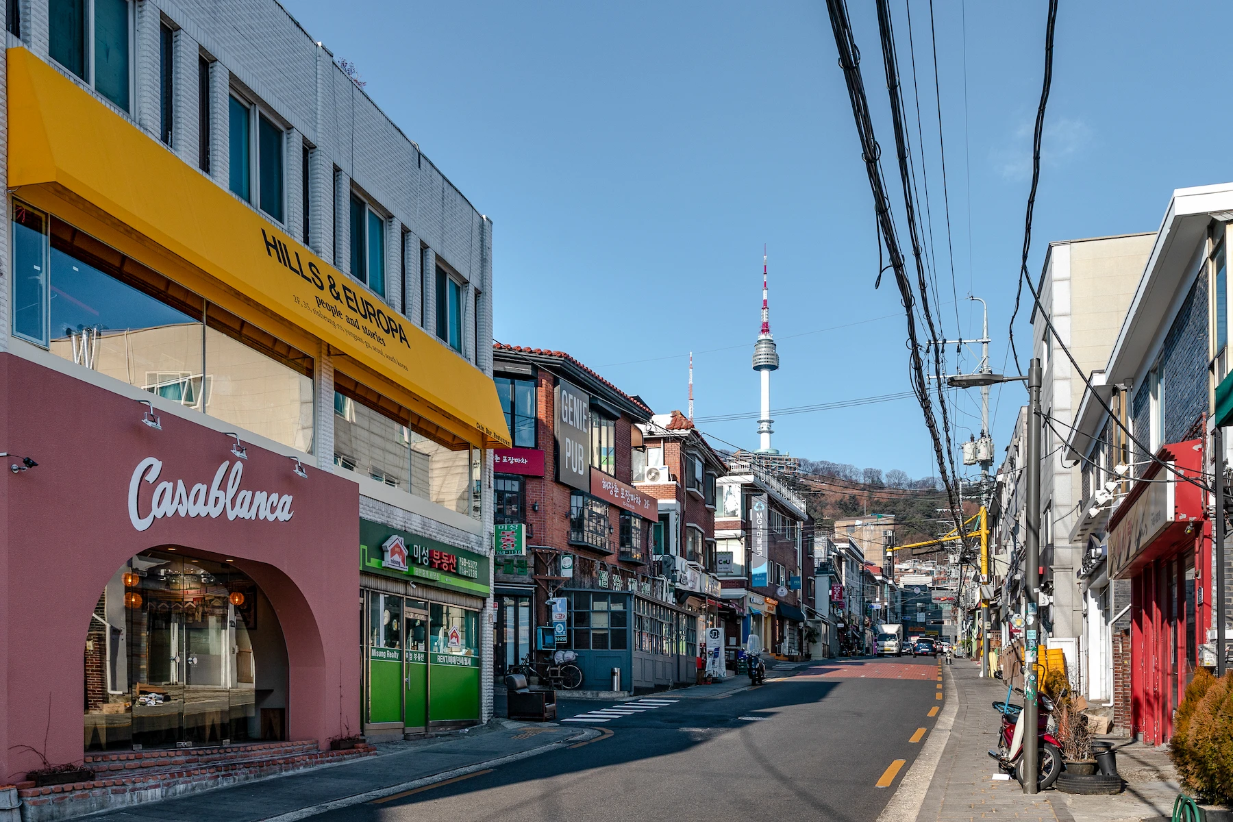 Haebangchon street in Itaewon with N Seoul Tower visible in the distance.